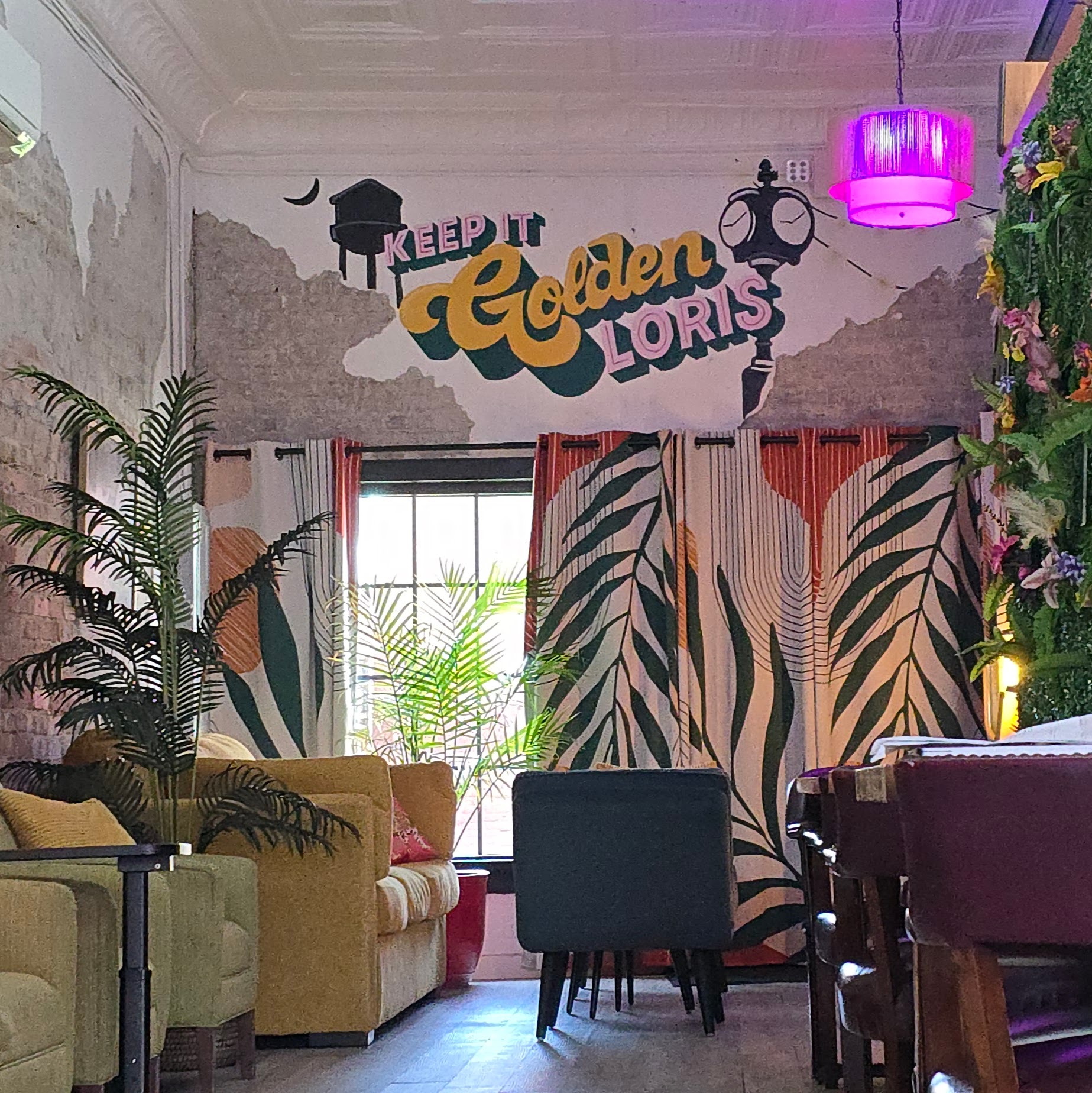 Inside Mattie Jane's — Keep It Golden Loris mural, plants, and lounge seating